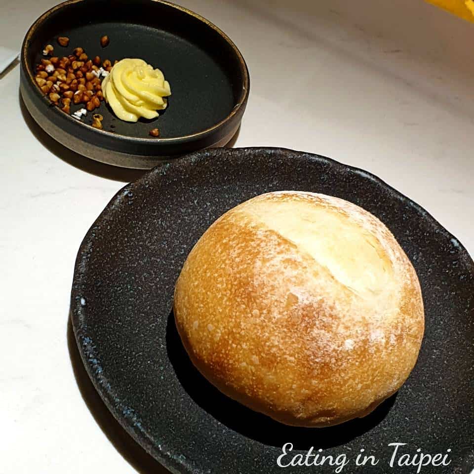 Their bread is a small round bun, served with smoked butter and toasted barley separately. 